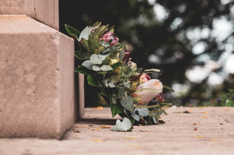 Wreath of flowers against the base of a gravestone
